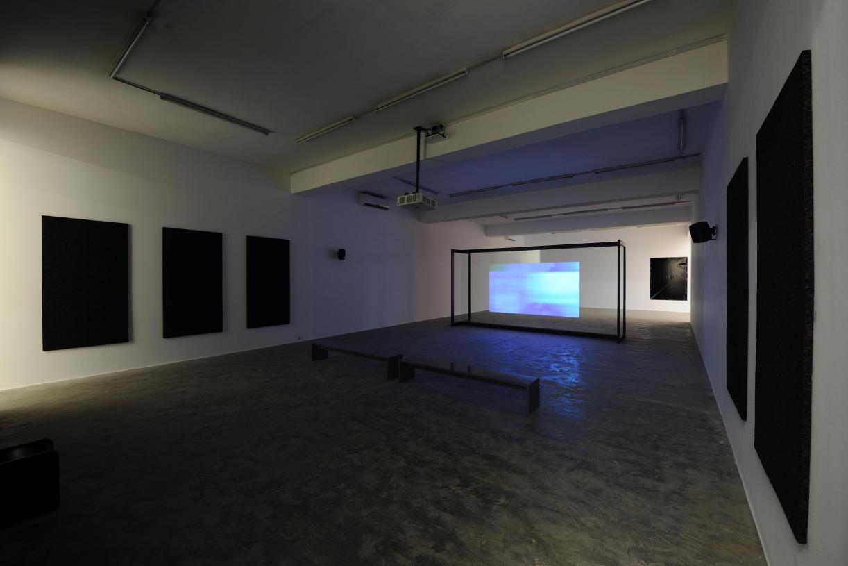 Walled Unwalled, 2018, Single-channel video, color, sound, Installation, with metal structure, glass & foil, 20 mins, Ed. 6 + 2 AP, Wall design in collaboration with Müller Aprahamian