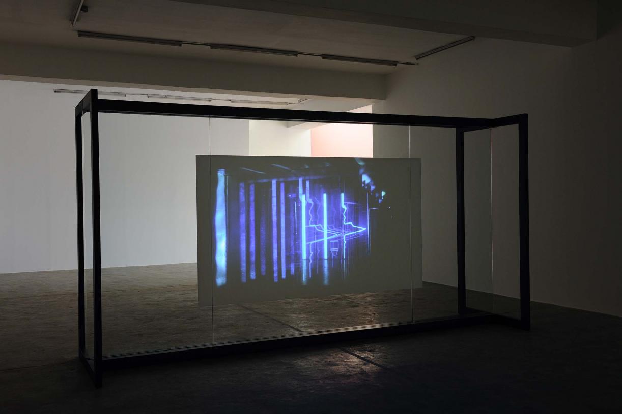 Walled Unwalled, 2018, Single-channel video, color, sound, Installation, with metal structure, glass & foil, 20 mins, Ed. 6 + 2 AP, Wall design in collaboration with Müller Aprahamian