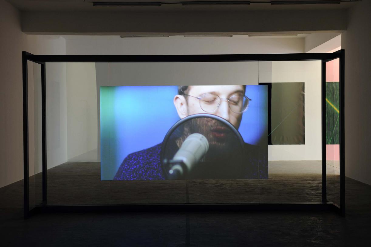 Walled Unwalled, 2018, Single-channel video, color, sound, Installation, with metal structure, glass & foil, 20 mins, Ed. 6 + 2 AP, Wall design in collaboration with Müller Aprahamian