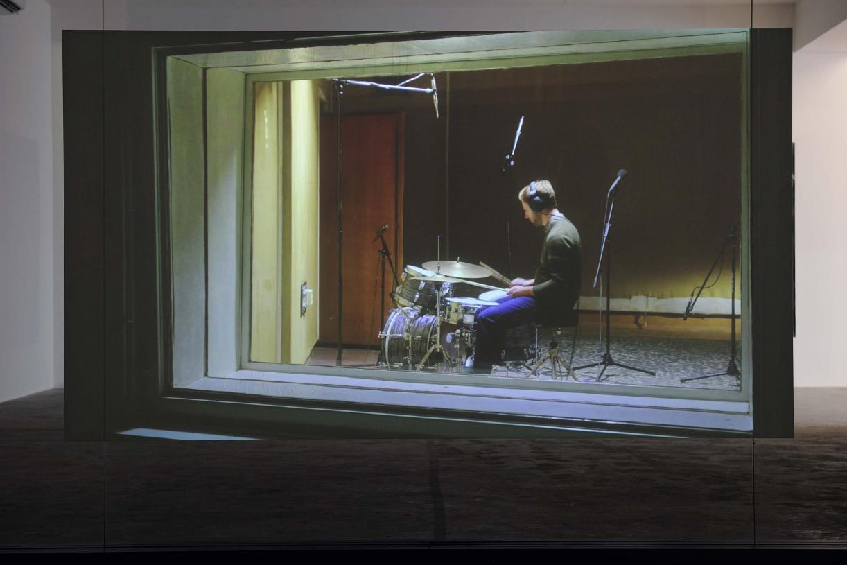 Walled Unwalled, 2018, Single-channel video, color, sound, Installation, with metal structure, glass & foil, 20 mins, Ed. 6 + 2 AP, Wall design in collaboration with Müller Aprahamian