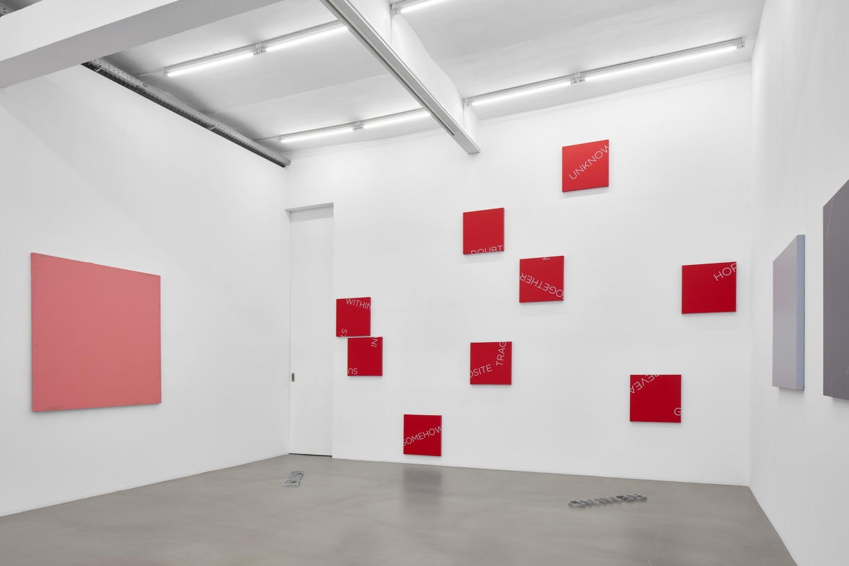Untitled, 2024, 19 red foil words on window, Dimensions variable