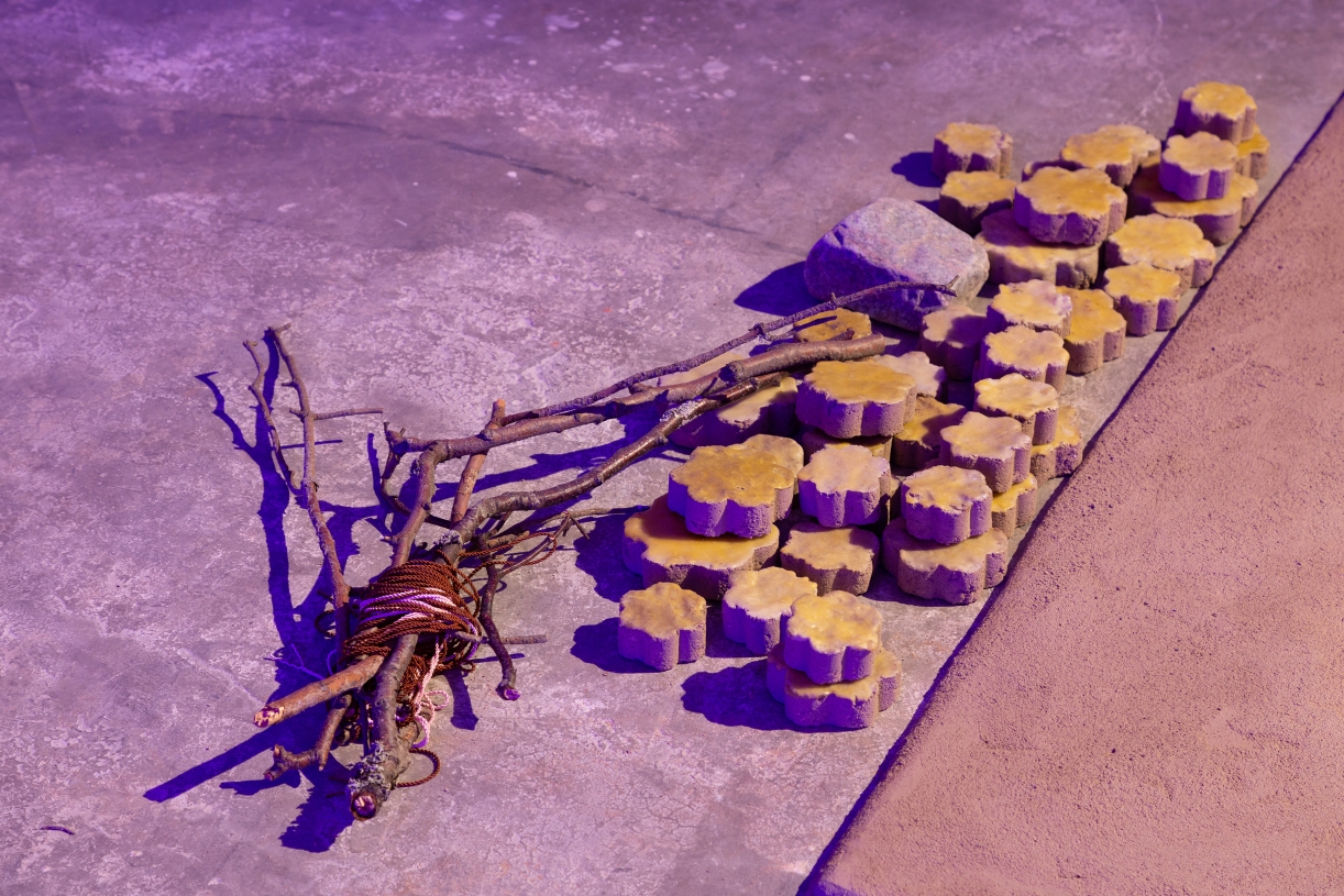 Dineo Seshee Bopape, (Ka) pheko ye ... (the moon piece), 2025 Clay, beeswax, granite, twigs, strings, 150 × 120 × 15, 3 + 2 AP