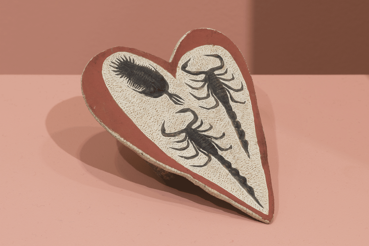 Lying Stone Hearts (Fake Fossil Series, two scorpions and trilobite), 2015, stone dust, plaster, car repair resin, shoe wax, black manganese dioxide from household batteries, red paint, stone slab, 9 x 10 x 15 cm