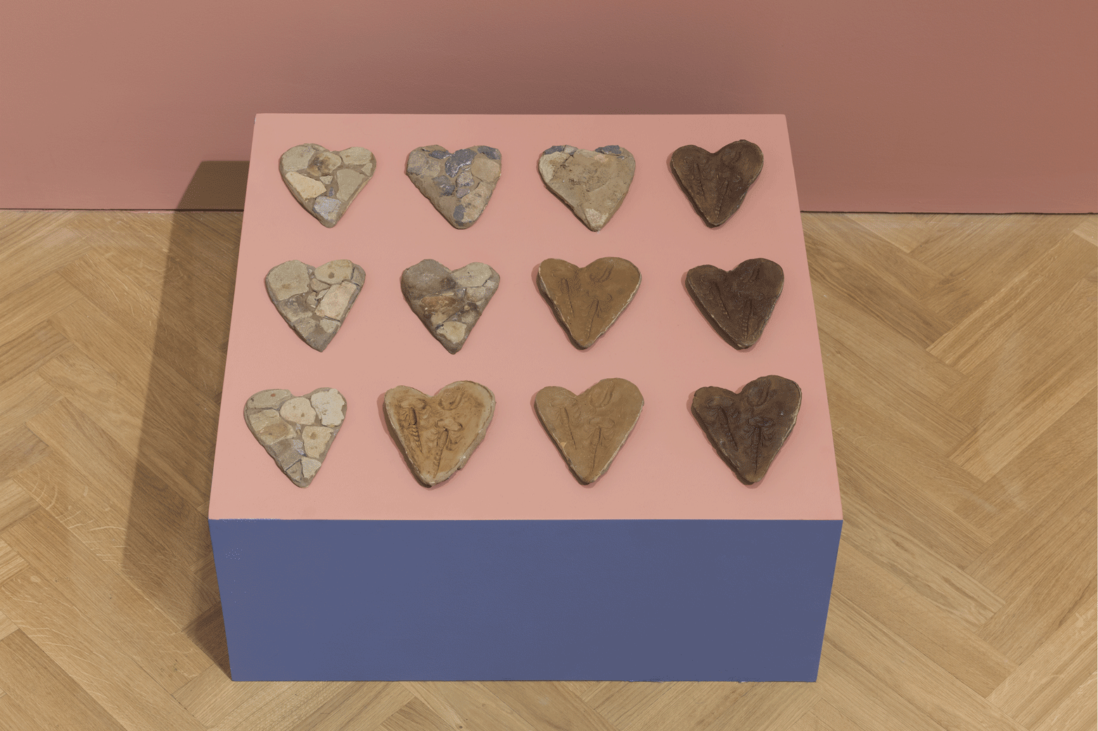 Moulds for Lying Stone Hearts (Fake Fossil Series, two scorpions and trilobite), 2015, stone dust, plaster, car repair resin, shoe wax, black manganese dioxide from household batteries, red paint, stone slab, 1 x 72 x 72 cm