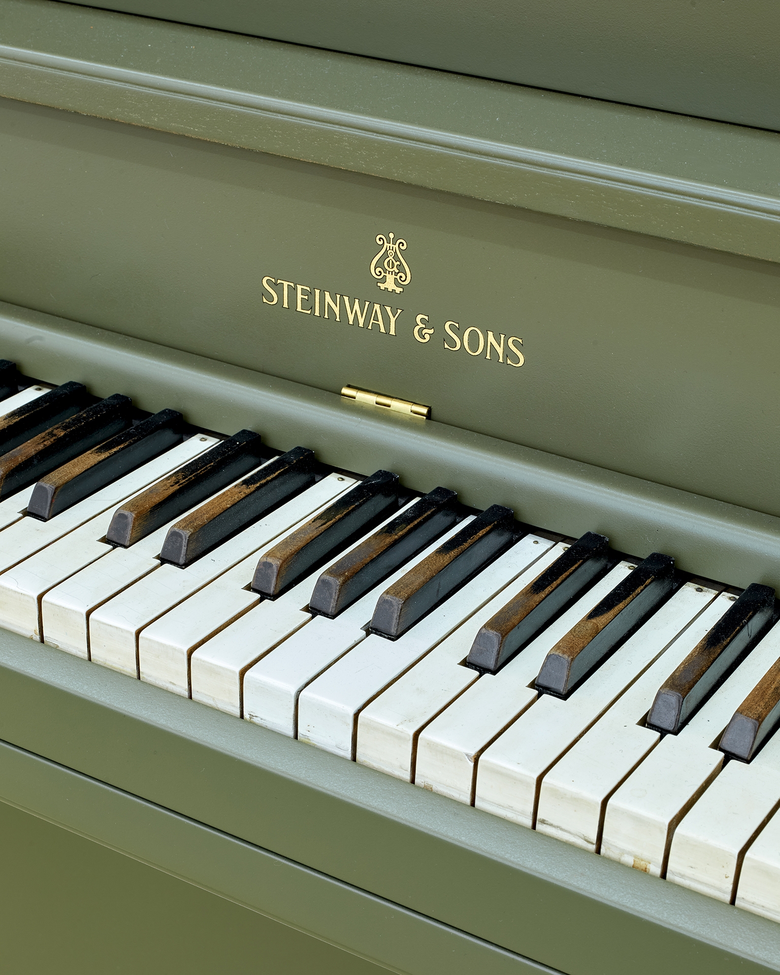 The Relief (Steinway Victory Vertical, 1944), 2025, Steinway Victory Vertical, 1944, piano crate, fiberglass, resin, paint , Piano: 144,5 × 167 × 49 cm, Crate: 121 × 161 × 76 cm, Unique