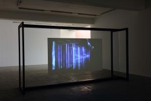 Walled Unwalled, 2018, Single-channel video, color, sound, Installation, with metal structure, glass & foil, 20 mins, Ed. 6 + 2 AP, Wall design in collaboration with Müller Aprahamian
