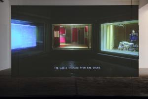 Walled Unwalled, 2018, Single-channel video, color, sound, Installation, with metal structure, glass & foil, 20 mins, Ed. 6 + 2 AP, Wall design in collaboration with Müller Aprahamian