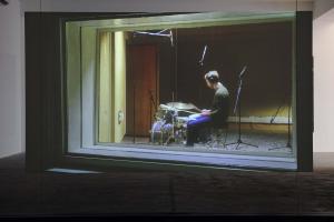 Walled Unwalled, 2018, Single-channel video, color, sound, Installation, with metal structure, glass & foil, 20 mins, Ed. 6 + 2 AP, Wall design in collaboration with Müller Aprahamian