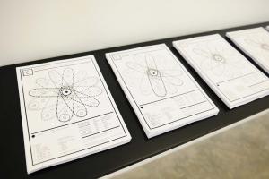 Conflicted Phonemes, 2012,  Timeline: Vinyl wallprint 267 x 205 cm,  Individual voice-maps, A4 black and white: vinyl wall prints & take away copies printed on embossed paper on a shelf. Wall print 265 x 205 cm; A4 papers 21 x 29.7 cm. Ed. 5 + 2 AP. Installation View, Sfeir-Semler Gallery Beirut, 2017