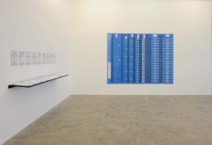 Conflicted Phonemes, 2012,  Timeline: Vinyl wallprint 267 x 205 cm,  Individual voice-maps, A4 black and white: vinyl wall prints & take away copies printed on embossed paper on a shelf. Wall print 265 x 205 cm; A4 papers 21 x 29.7 cm. Ed. 5 + 2 AP. Installation View, Sfeir-Semler Gallery Beirut, 2017
