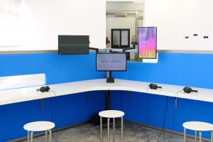 The Whole Truth, 2012, Reverse engineered lie detector, 3 channel video, stereo sound, desk, 3 chairs, 3 artificial plants, 24 minutes, 612 x 435 x 190 cm, Ed.5 + 2 AP