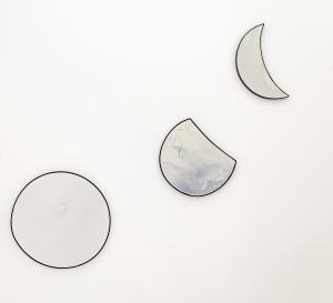Moon(s), 2024, Beeswax, oil paint on iron and wood, Ø 60 cm (full moon), 45 × 40 cm (waxing gibbous), 46 × 33 cm (waning crescent)