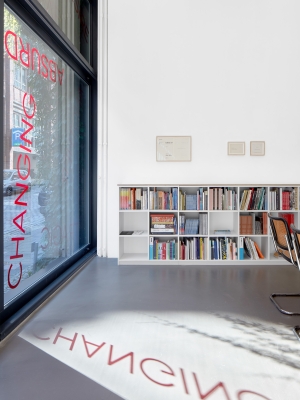 Untitled, 2024, 19 red foil words on window, Dimensions variable